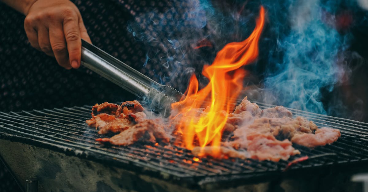 Close-Up Photo of Man Cooking Meat