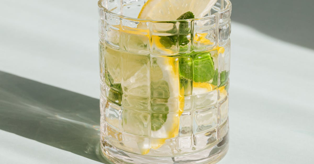 Glass of fresh drink on white background