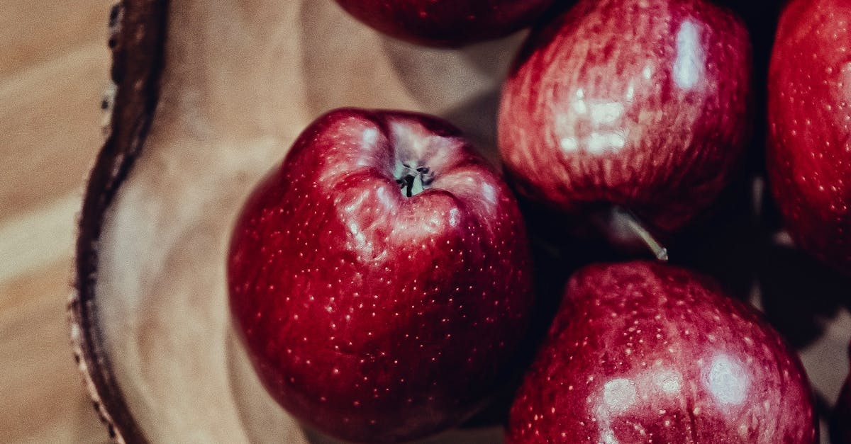 A bowl of red apples on a wooden table