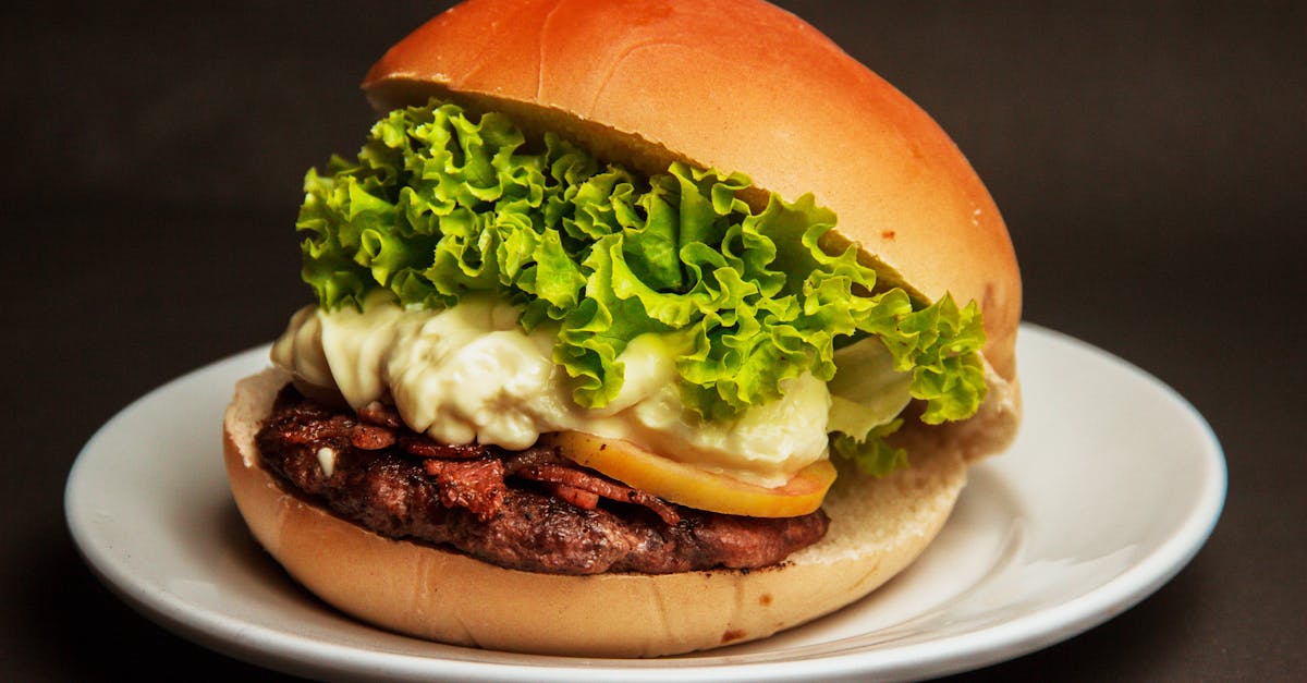 Burger With Lettuce and Cheese on a White Plate