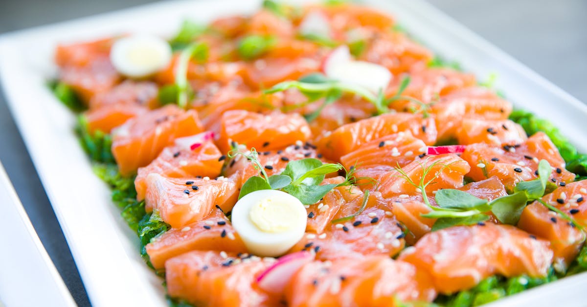 Salmon with greens and quail eggs on banquet table