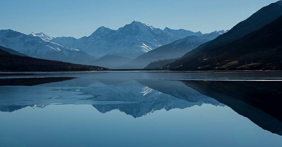 Calm Body of Lake Between Mountains