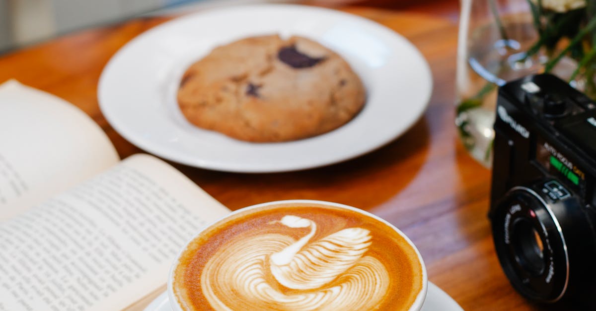 Aromatic latte served on table near book