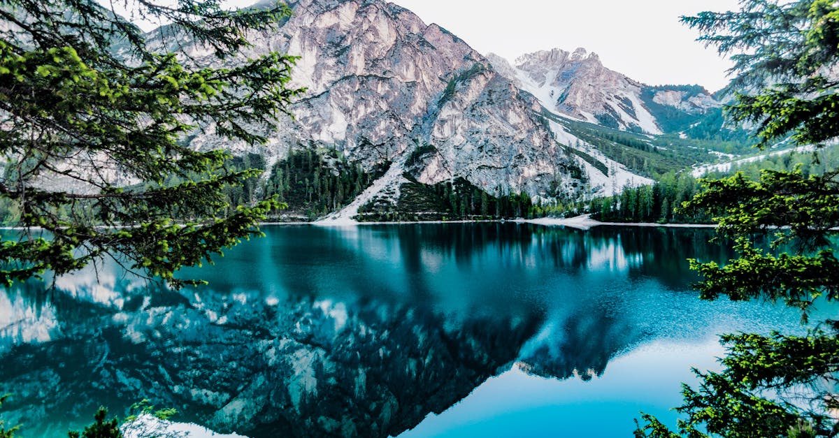 Lake and Mountain Under White Sky