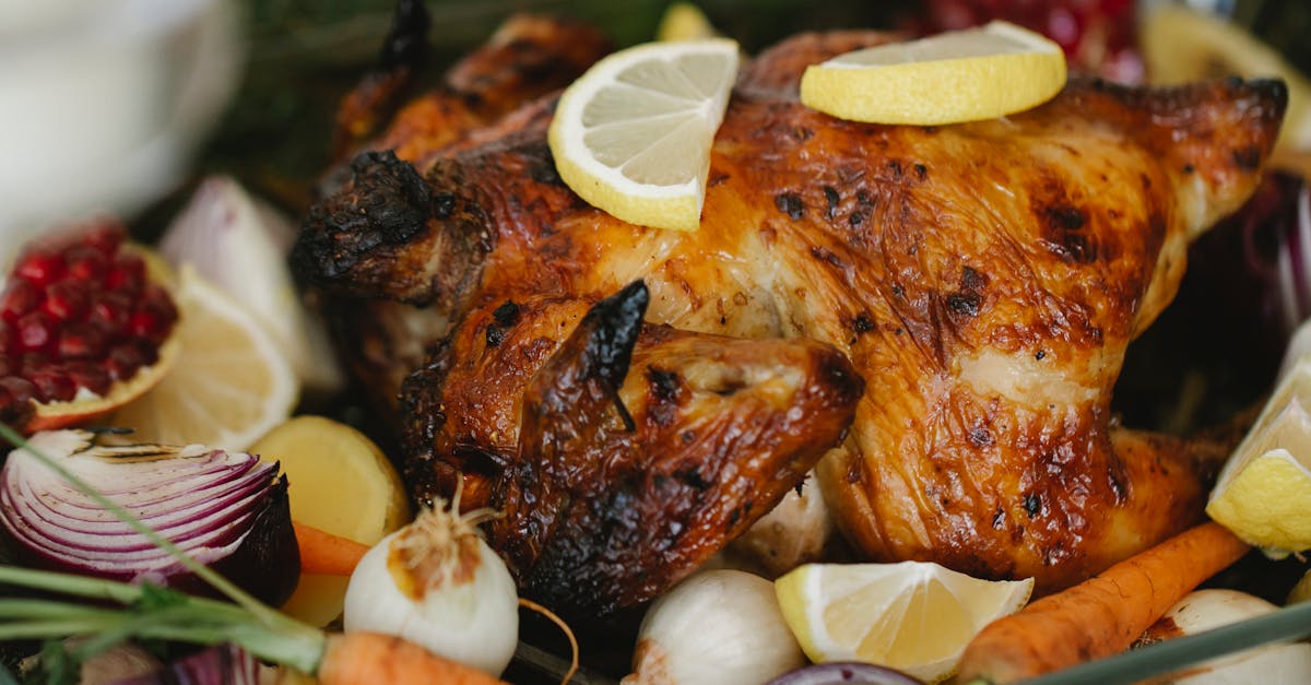 Roasted chicken with vegetables in glass roaster on table with fir sprigs