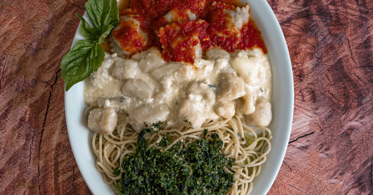 A plate of spaghetti and meatballs with sauce