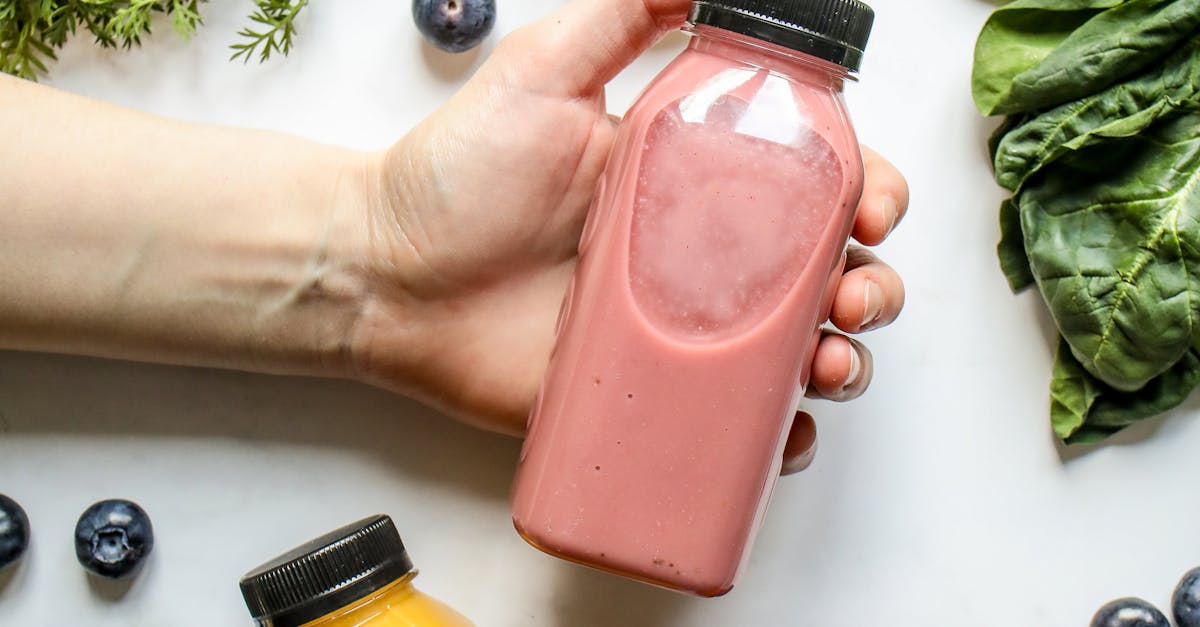 Person Holding Bottle with Smoothie