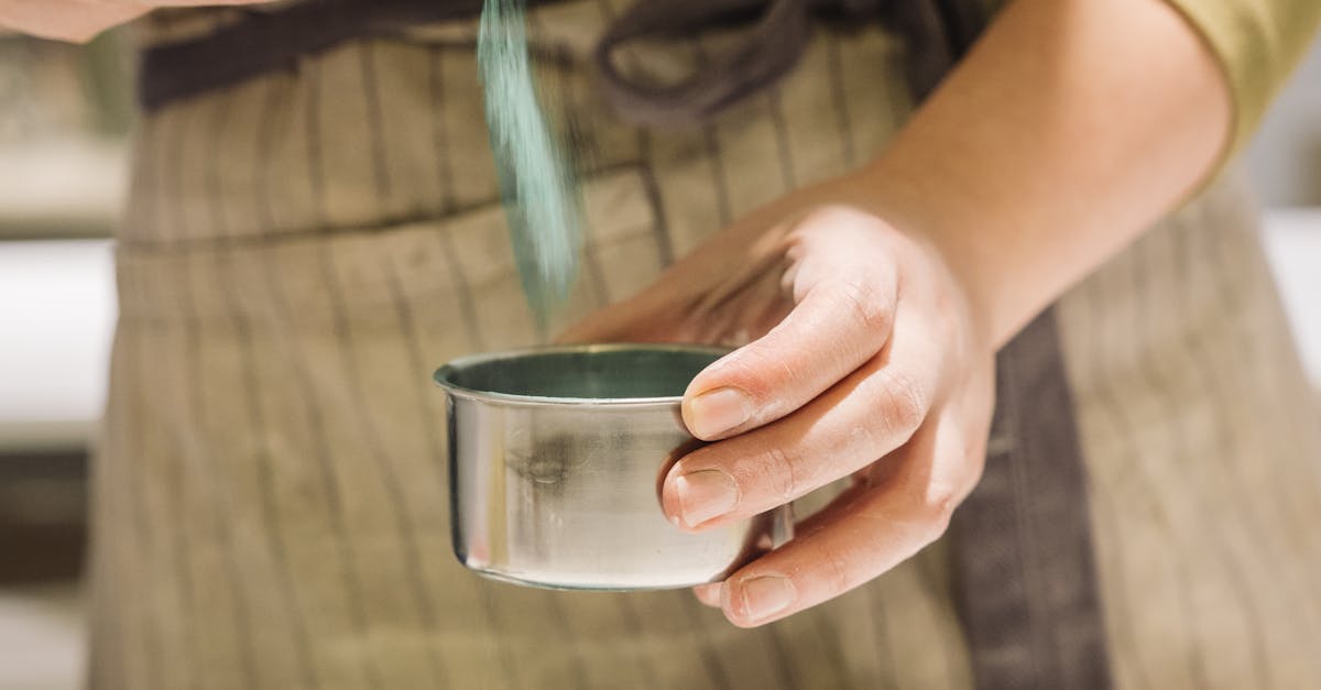 A woman in an apron is mixing blue paint