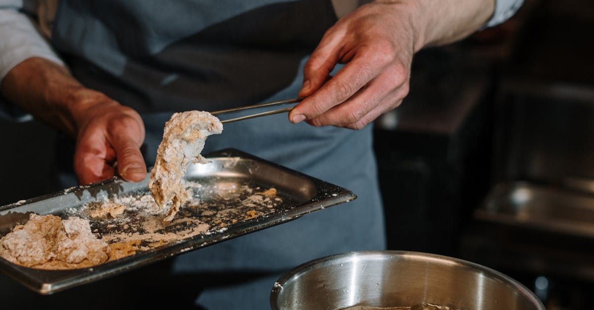 Person Holding Knife Slicing Meat