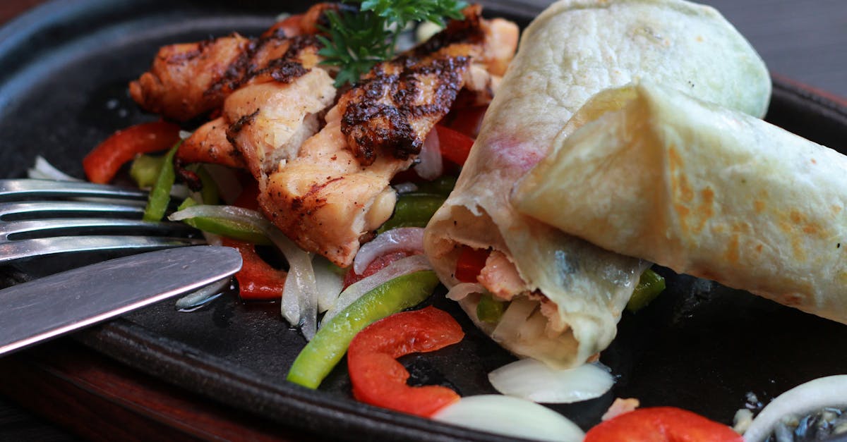 Meats and Vegetables on Black Oval Sizzling Plate