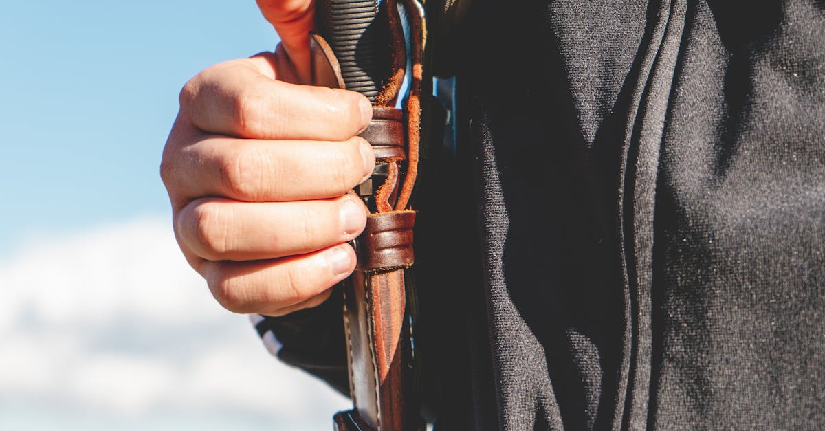 Crop man with knife in case