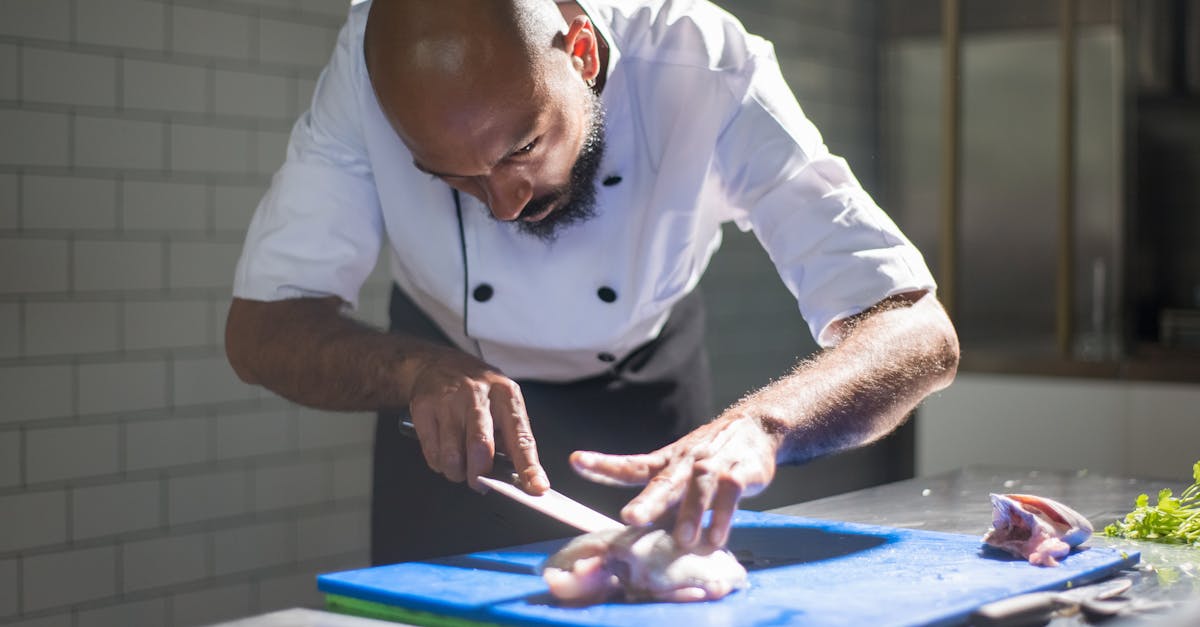 Man in White Chef Slicing a Meat 