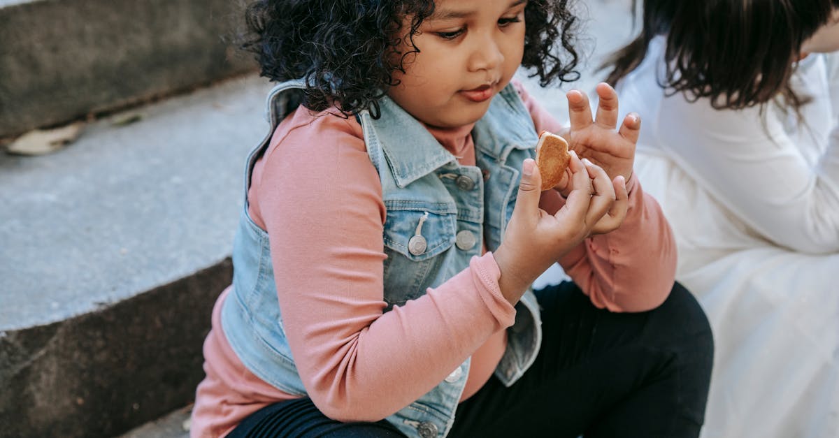 Black girl having gingerbread treat with friend