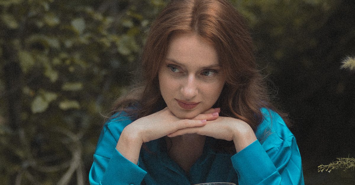 Woman in Turquoise Pyjamas Sitting at Breakfast Table in Garden