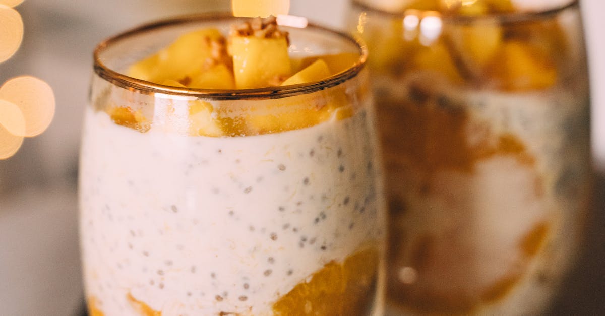 Glasses of Mango and Orange Chia Pudding on Wooden Tray