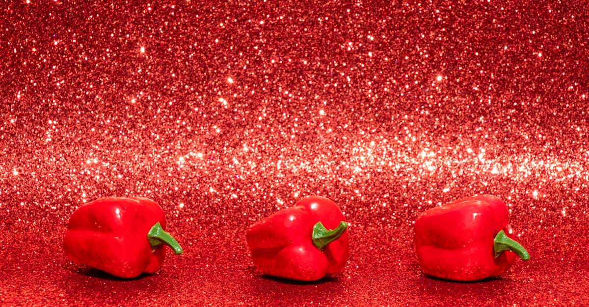 Three Red Bell Peppers on Red Surface