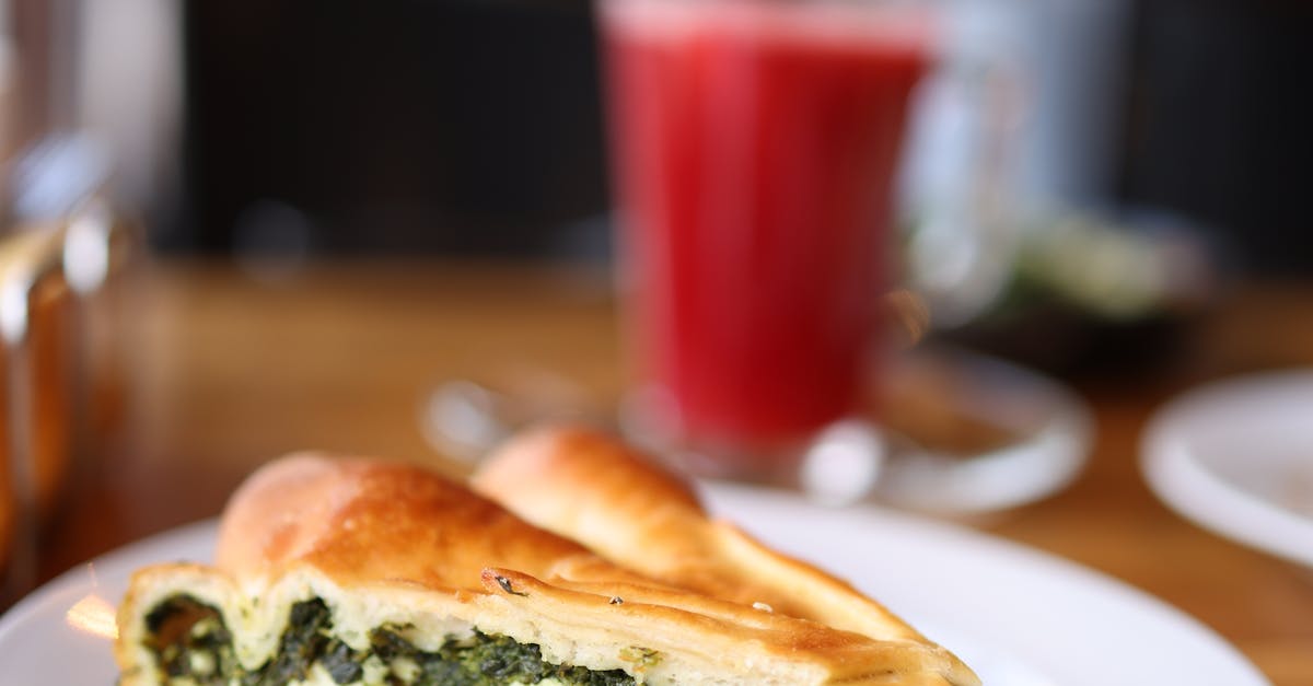 A slice of cheese and spinach pie on a plate