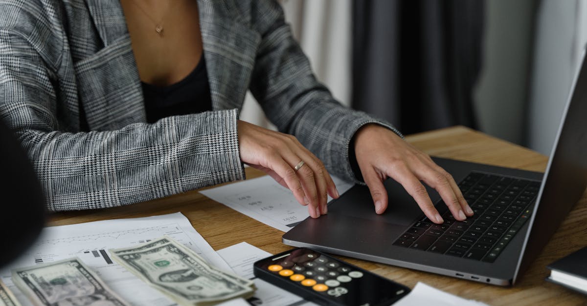 A Woman in Plaid Blazer Using Her Laptop