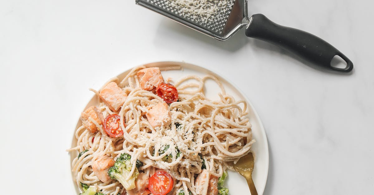 Pasta Dish on White Ceramic Plate Beside the Cheese