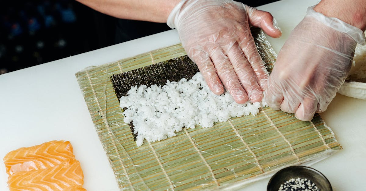 Person Making Sushi Roll