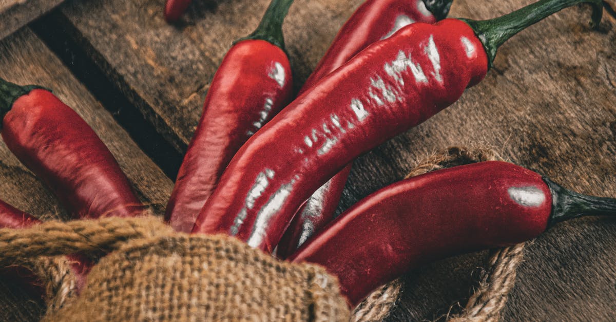 Red chili peppers in a sack on a wooden table