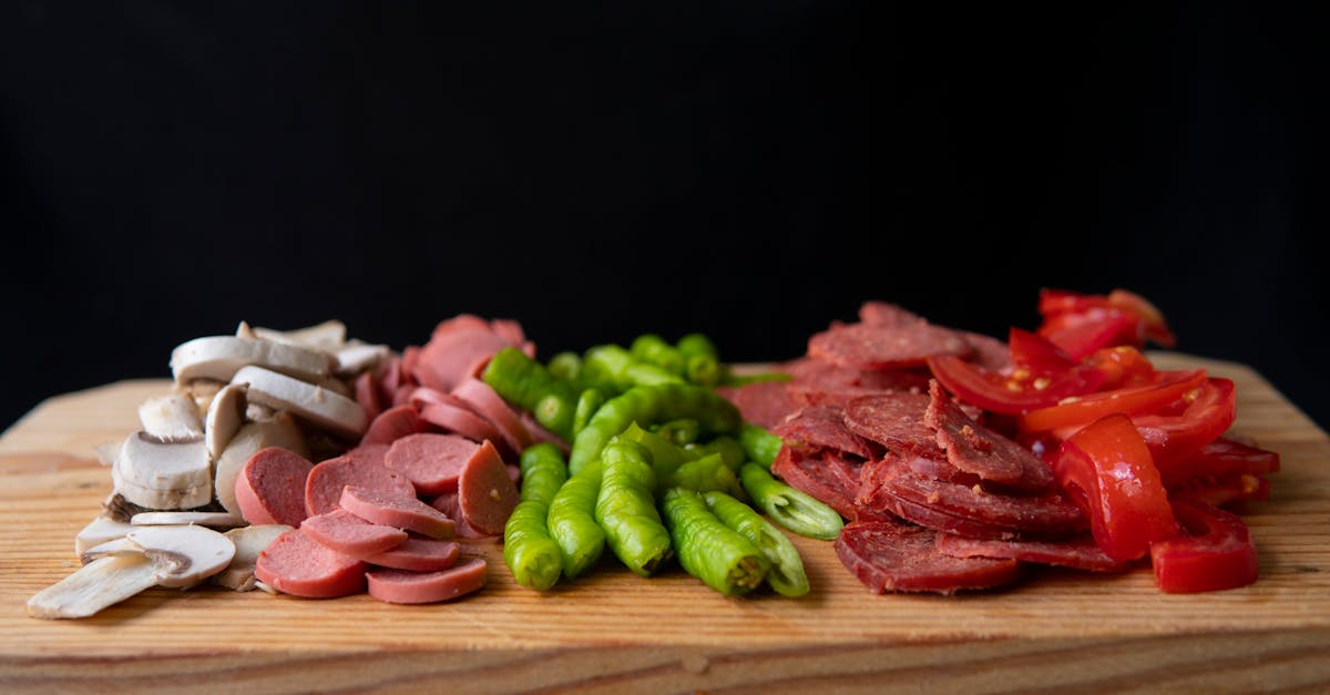 Pizza ingredients placed on wooden cutting board