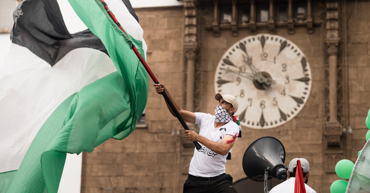 Palestinian flag in front of a clock tower