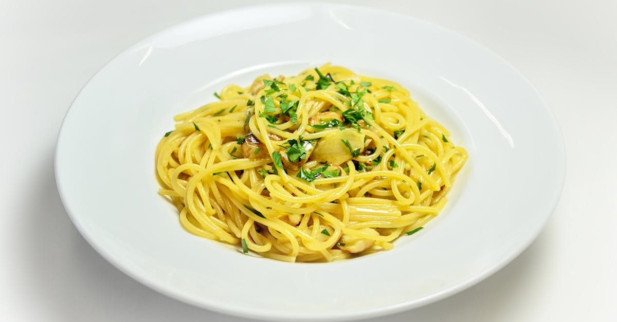 Spaghetti Aglio e Olio with Chopped Basil on White Plate