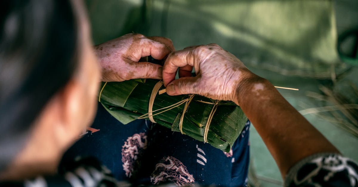 Hands of a Woman Wrapping Rice in Banana Leaves