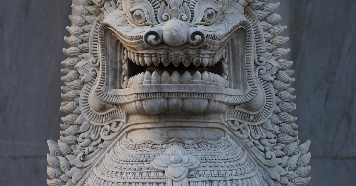 A lion statue in front of a pillar