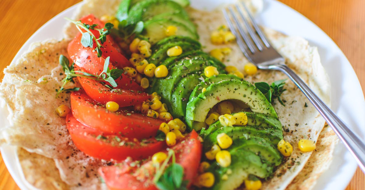 Sliced Tomato and Avocado on White Plate