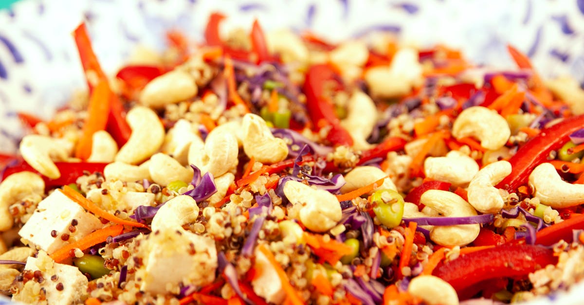 Closeup bowl of vegetarian salad made of couscous and pepper with cashew and tofu