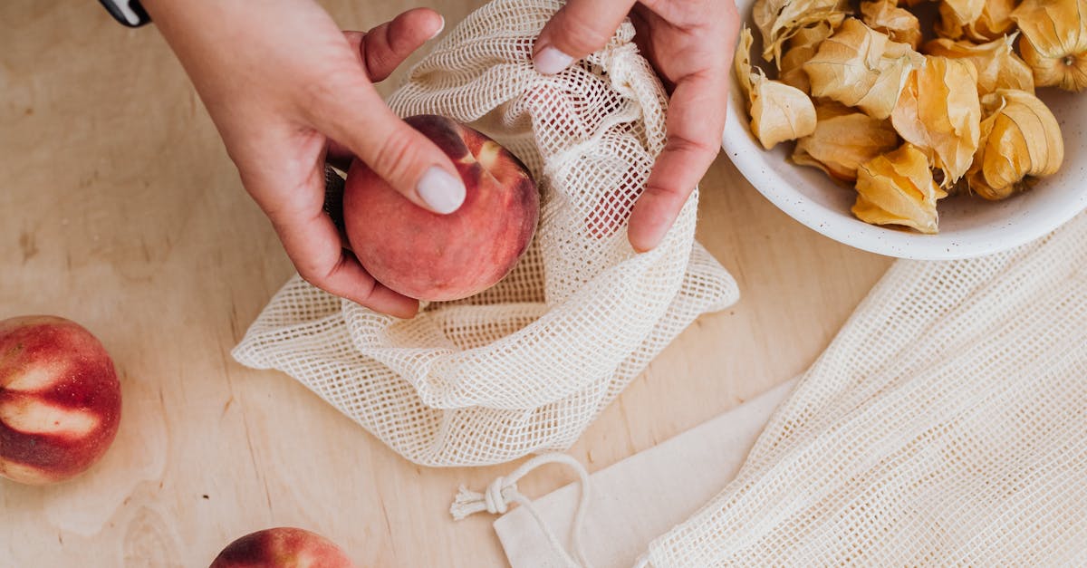 Putting Peach in Cotton Bag in Kitchen